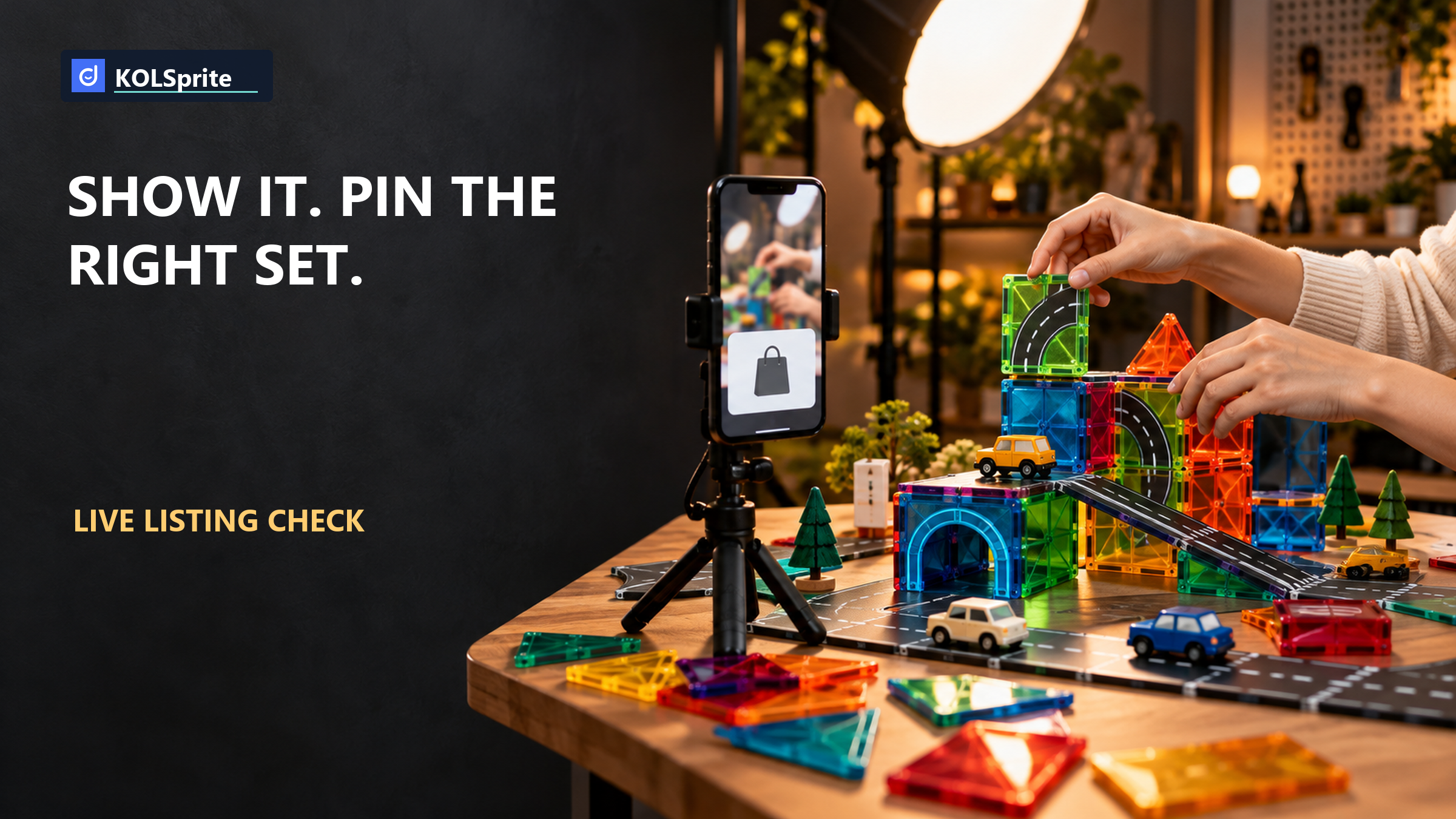 Hands arrange colorful magnetic road tiles beside a phone with a shopping bag symbol for a TikTok LIVE product listing review.